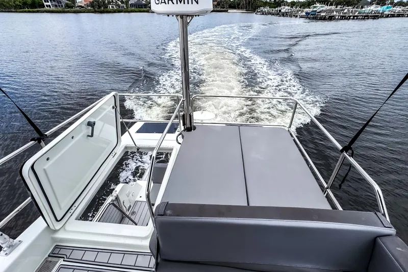 Slide: The Image of 2022 Beneteau Antares 11 Fly cruising on water, rear view with open deck. - 41