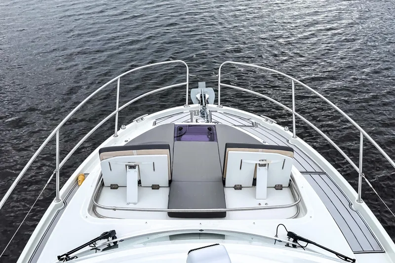 Slide: The Image of 2022 Beneteau Antares 11 Fly boat deck with seating, overlooking calm water. - 42