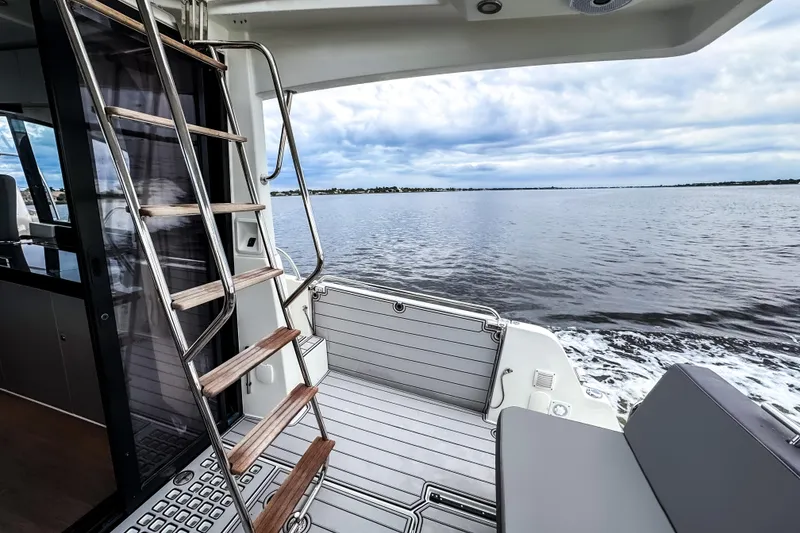 Slide: The Image of Beneteau Antares 11 Fly 2022 yacht interior with ocean view and wooden ladder. - 6