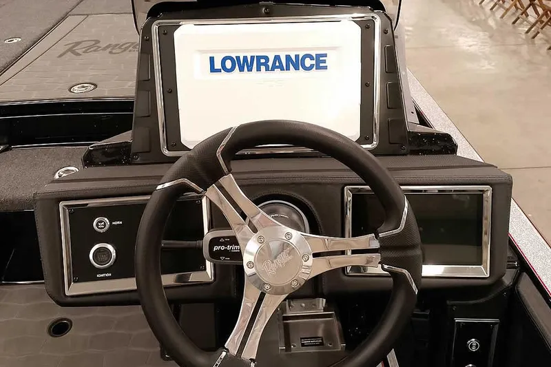 Slide: The Image of 2026 Ranger Z521R Cup-Equipped boat dashboard with Lowrance display and steering wheel. - 22
