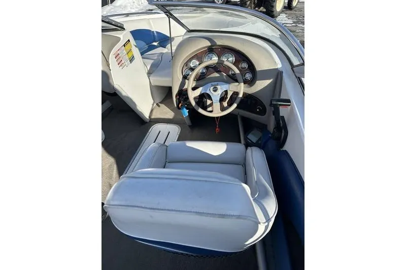 Slide: The Image of 2000 Ebbtide 210 Bow Rider boat interior with steering wheel and dashboard gauges. - 10