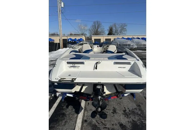 Slide: The Image of 2000 Ebbtide 210 Bow Rider boat, rear view, parked outdoors on a sunny day. - 11