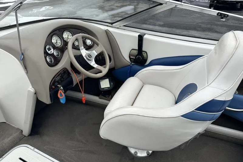 Slide: The Image of Interior of 2000 Ebbtide 210 Bow Rider boat with steering wheel and captain's seat. - 12