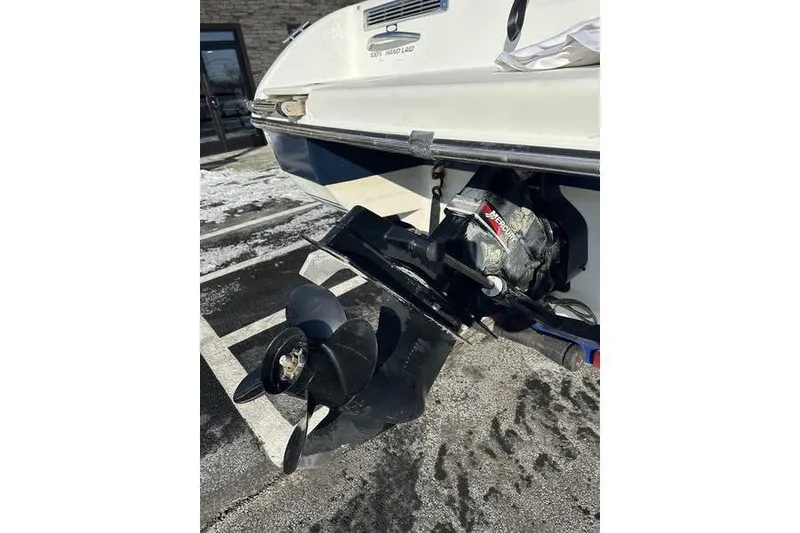 Slide: The Image of Rear view of 2000 Ebbtide 210 Bow Rider boat with visible propeller and outdrive. - 13