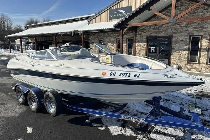 Slide: The Image of 2000 Ebbtide 210 Bow Rider boat on trailer, parked outside Bennington building. - 4