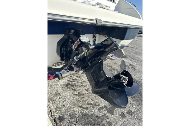 Slide: The Image of 2000 Ebbtide 210 Bow Rider boat with Mercury outboard motor, rear view. - 6