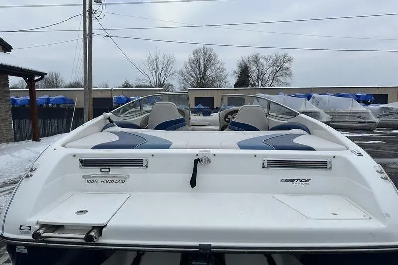 Slide: The Image of 2000 Ebbtide 210 Bow Rider boat, rear view, parked outdoors in winter. - 7
