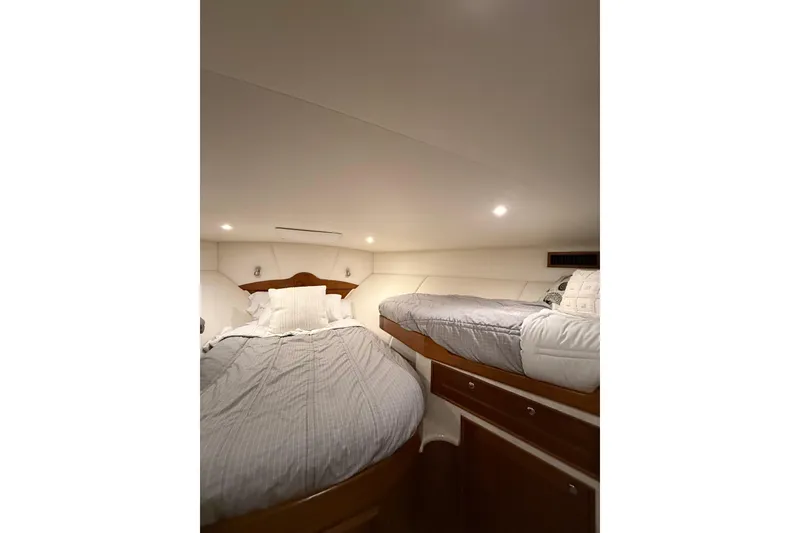 Slide: The Image of Interior cabin of 2006 Blackwell 66 Convertible yacht with twin beds and wooden accents. - 12