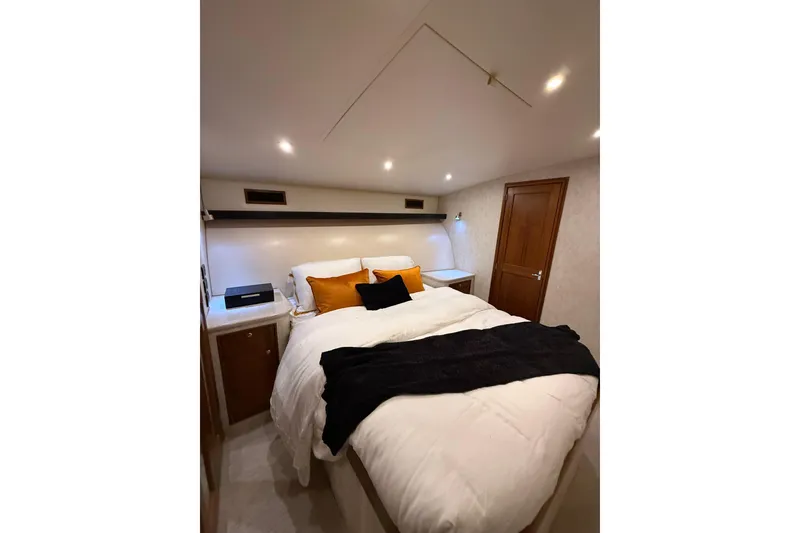 Slide: The Image of Luxurious bedroom interior in 2006 Blackwell 66 Convertible yacht, featuring cozy bedding and ambient lighting. - 13