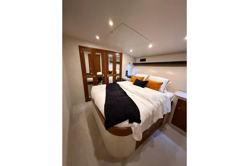 Slide: The Image of Luxurious bedroom interior of 2006 Blackwell 66 Convertible yacht with elegant bedding and lighting. - 16