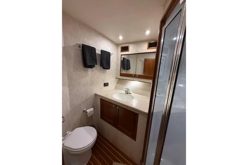 Slide: The Image of Luxurious bathroom in 2006 Blackwell 66 Convertible yacht with modern fixtures and wooden accents. - 17