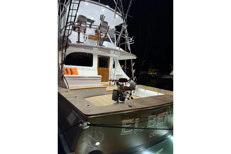 Slide: The Image of 2006 Blackwell 66 Convertible yacht at night, featuring a spacious deck and seating area. - 2
