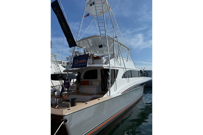 Slide: The Image of 2006 Blackwell 66 Convertible yacht docked, featuring a sleek design and fishing equipment. - 28