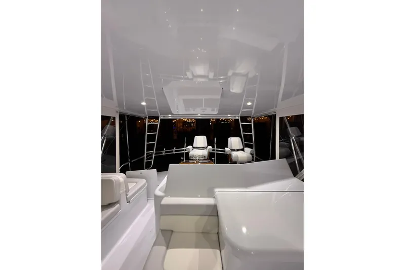Slide: The Image of Interior of a 2006 Blackwell 66 Convertible yacht, featuring sleek white seating and modern design. - 6