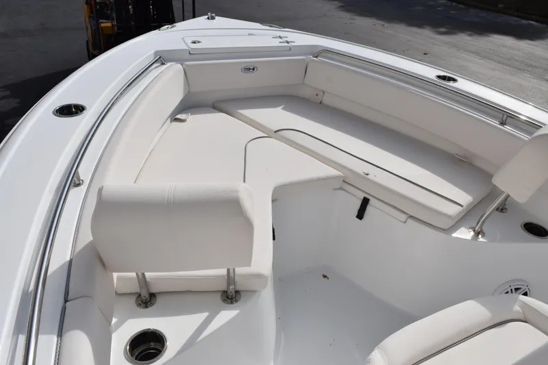 Slide: The Image of 2026 Sea Hunt Ultra 219 boat interior with white seating and stainless steel railings. - 13
