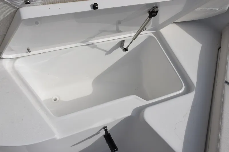 Slide: The Image of Open storage compartment on 2026 Sea Hunt Ultra 219 boat. - 16