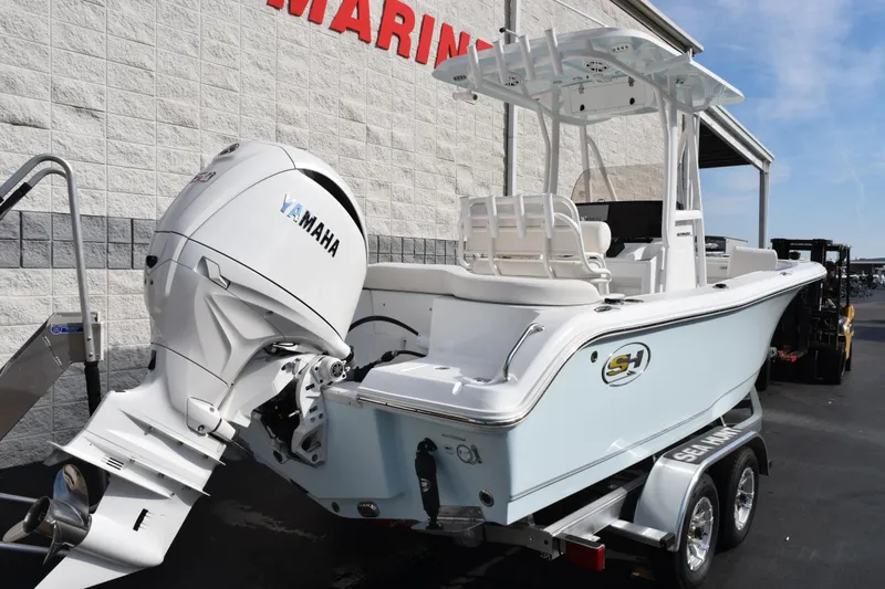 Slide: The Image of 2026 Sea Hunt Ultra 219 boat with Yamaha engine on trailer outside marine store. - 4