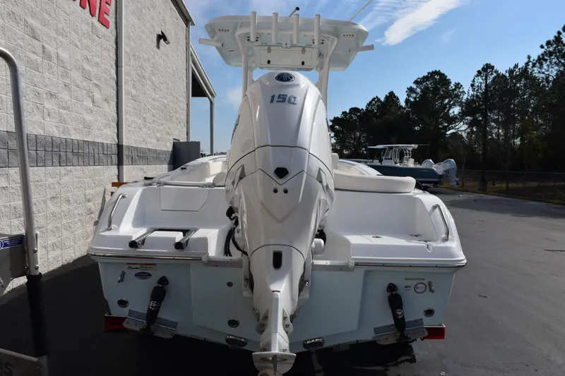 Slide: The Image of 2026 Sea Hunt Ultra 219 boat with powerful outboard motor, parked outdoors. - 5