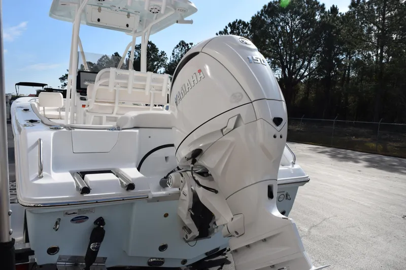 Slide: The Image of 2026 Sea Hunt Ultra 219 boat with Yamaha outboard motor, parked outdoors. - 6