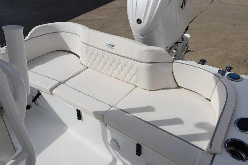 Slide: The Image of 2026 Sea Hunt Ultra 219 boat with white cushioned seating and motor. - 9