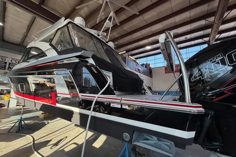 Slide: The Image of 2017 Formula 430 Super Sport Crossover boat in a workshop, showcasing sleek design and powerful engine. - 10