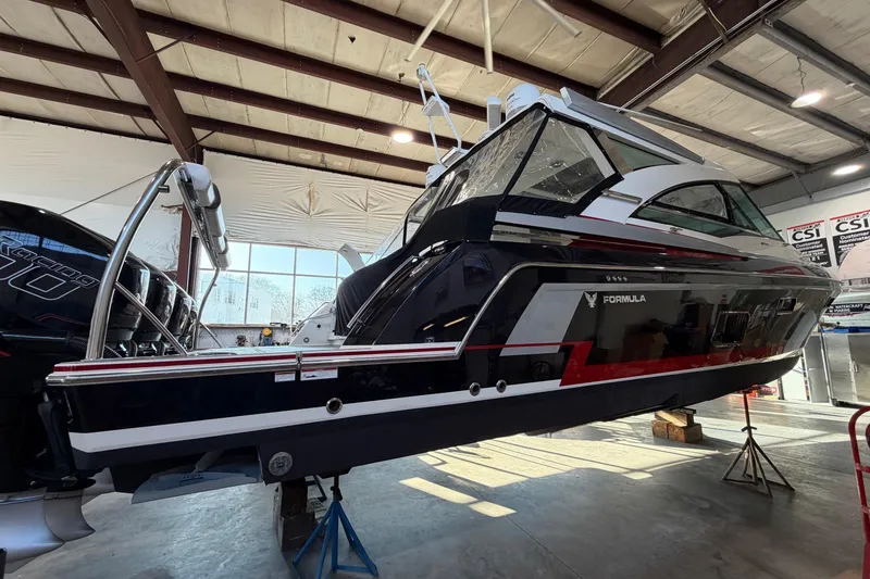 Slide: The Image of 2017 Formula 430 Super Sport Crossover boat in a warehouse setting. - 12