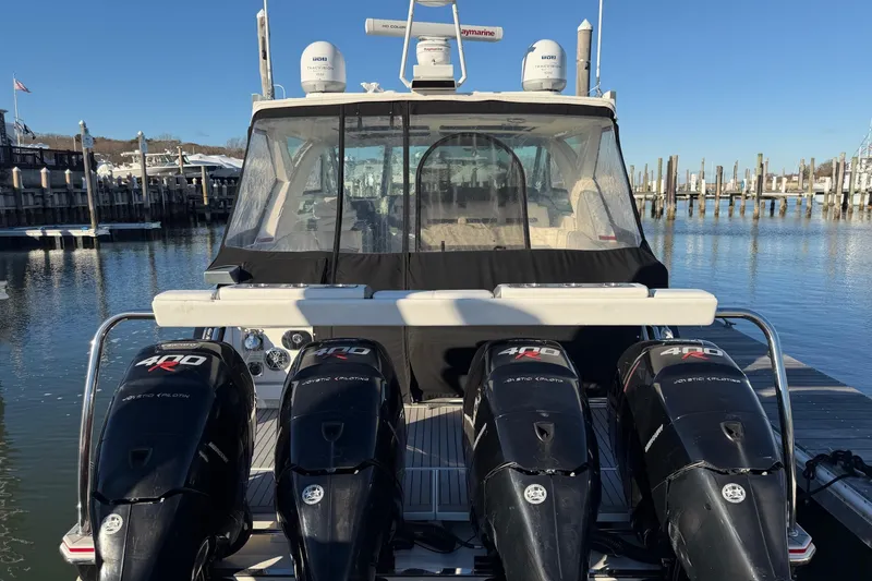 Slide: The Image of 2017 Formula 430 Super Sport Crossover with four powerful outboard engines docked at marina. - 2