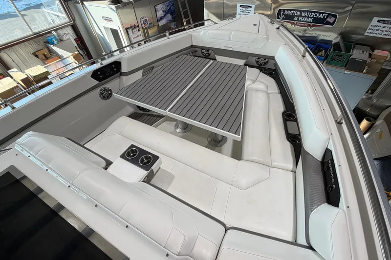 Slide: The Image of 2017 Formula 430 Super Sport Crossover boat interior with white seating and table. - 40