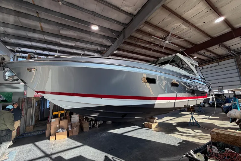 Slide: The Image of 2017 Formula 430 Super Sport Crossover yacht in a boatyard, elevated for maintenance. - 48
