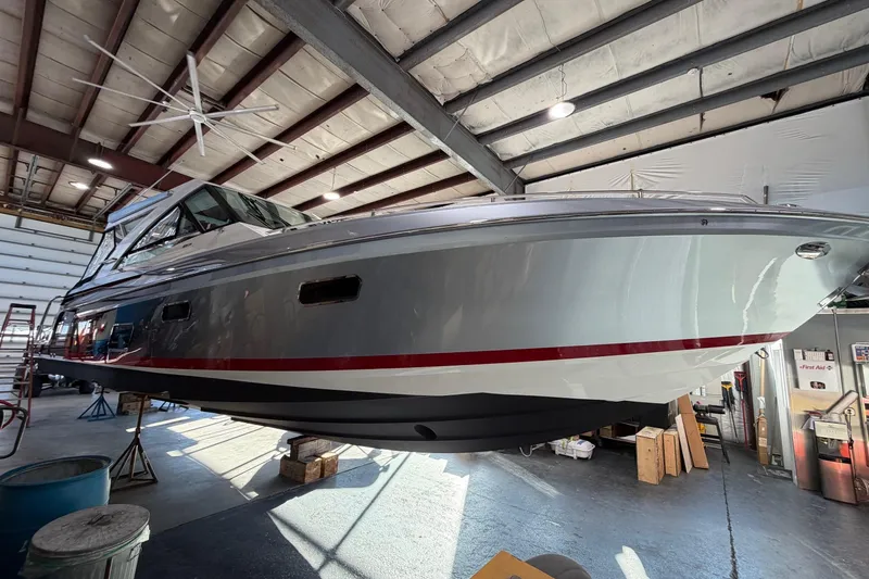 Slide: The Image of 2017 Formula 430 Super Sport Crossover boat in a warehouse, elevated for maintenance. - 50