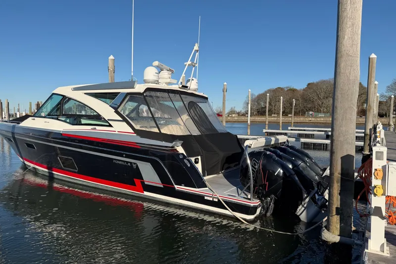 Slide: The Image of 2017 Formula 430 Super Sport Crossover boat docked at marina, clear blue sky. - 51