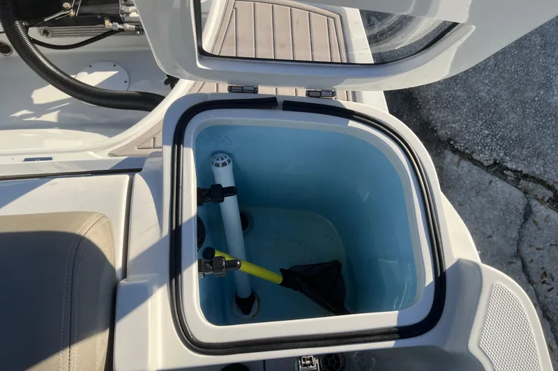 Slide: The Image of Open storage compartment on 2022 Finseeker 280 DC boat, showing interior details. - 10