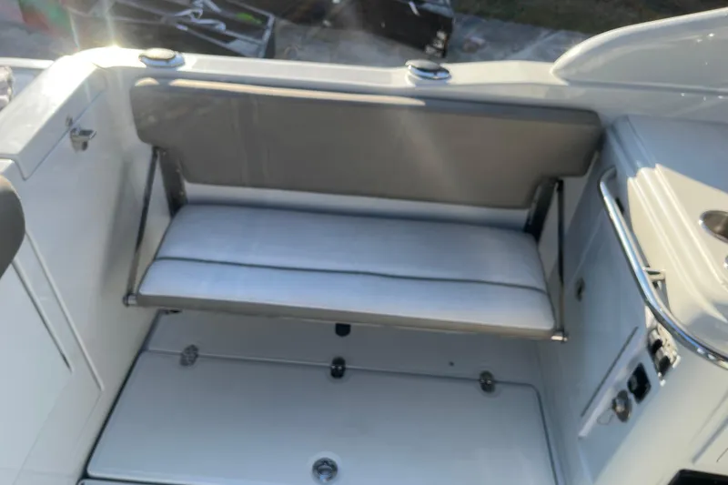 Slide: The Image of 2022 Finseeker 280 DC boat interior with foldable seat and storage compartment. - 11