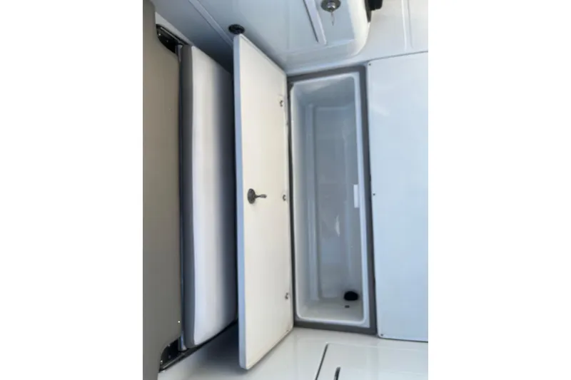 Slide: The Image of 2022 Finseeker 280 DC boat storage compartment with open hatch, showcasing interior space. - 12