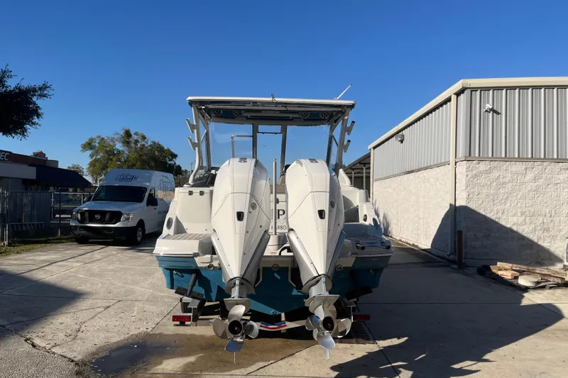 Slide: The Image of 2022 Finseeker 280 DC boat with dual outboard motors in a sunny outdoor setting. - 24