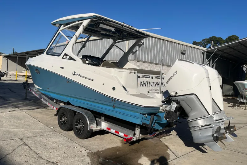 Slide: The Image of 2022 Finseeker 280 DC boat with dual Mercury engines on a trailer. - 25