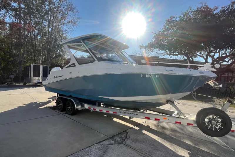 Slide: The Image of 2022 Finseeker 280 DC boat on trailer under bright sunlight. - 29