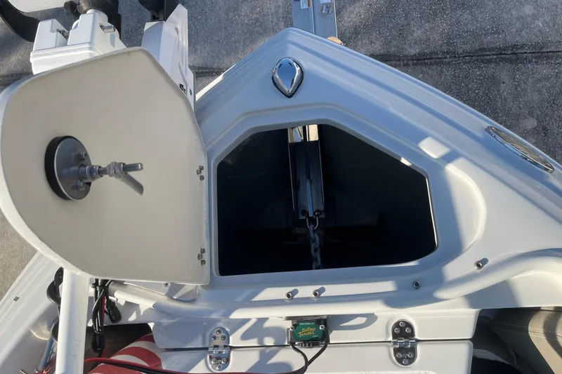 Slide: The Image of Open anchor compartment on a 2022 Finseeker 280 DC boat, showing chain and mechanism. - 31