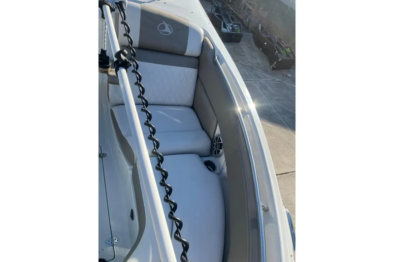 Slide: The Image of 2022 Finseeker 280 DC boat interior with cushioned seating and cup holders. - 33