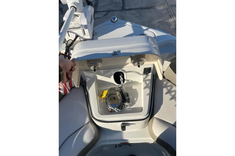 Slide: The Image of 2022 Finseeker 280 DC boat compartment with open hatch and visible equipment. - 34