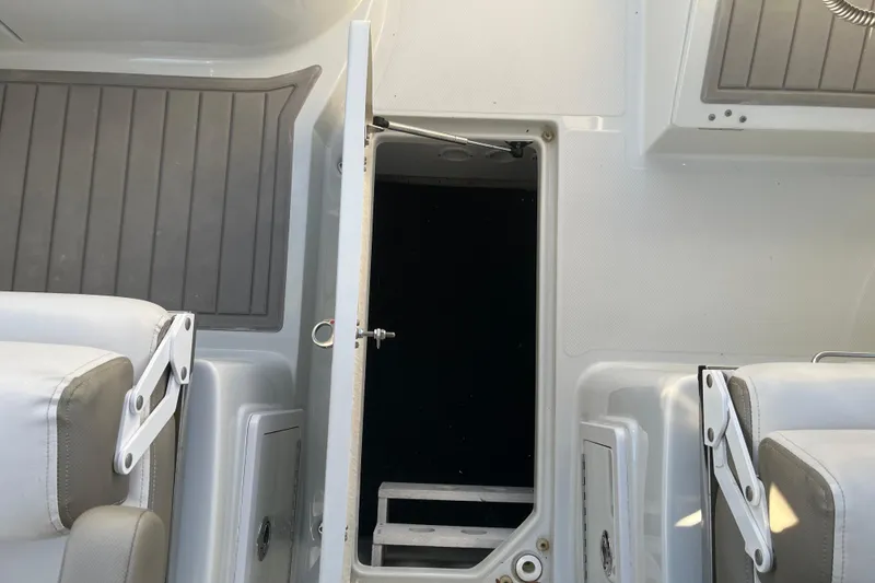 Slide: The Image of Interior view of a 2022 Finseeker 280 DC boat, featuring seating and storage compartments. - 4
