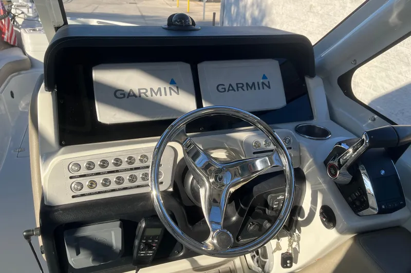 Slide: The Image of Cockpit of 2022 Finseeker 280 DC with Garmin navigation displays and steering wheel. - 5