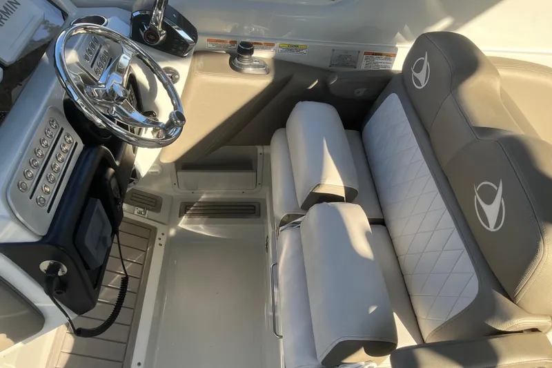 Slide: The Image of 2022 Finseeker 280 DC boat interior with steering wheel and cushioned seating. - 6