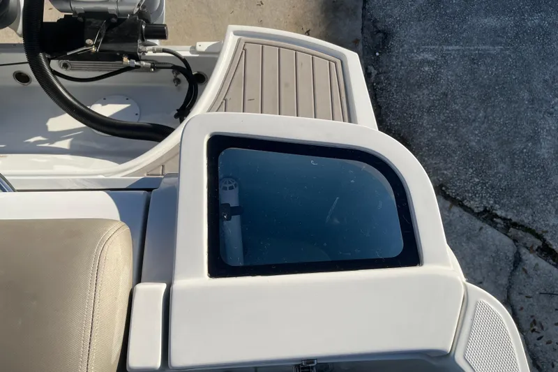 Slide: The Image of 2022 Finseeker 280 DC boat interior with seating and control panel. - 9