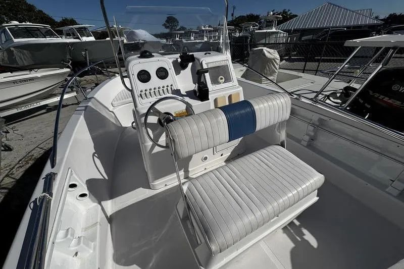 Slide: The Image of 2002 Pro-Line 19 Sport boat interior with steering console and seating. - 10