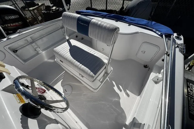 Slide: The Image of 2002 Pro-Line 19 Sport boat interior with steering wheel and cushioned seating. - 12