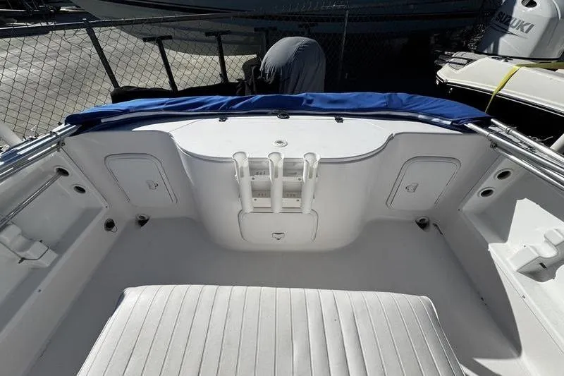 Slide: The Image of 2002 Pro-Line 19 Sport boat interior with white seating and blue cover. - 17