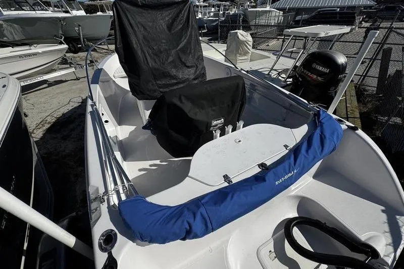 Slide: The Image of 2002 Pro-Line 19 Sport boat with Yamaha outboard motor, docked in a marina. - 2