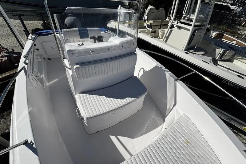 Slide: The Image of 2002 Pro-Line 19 Sport boat interior with white seating and console. - 6