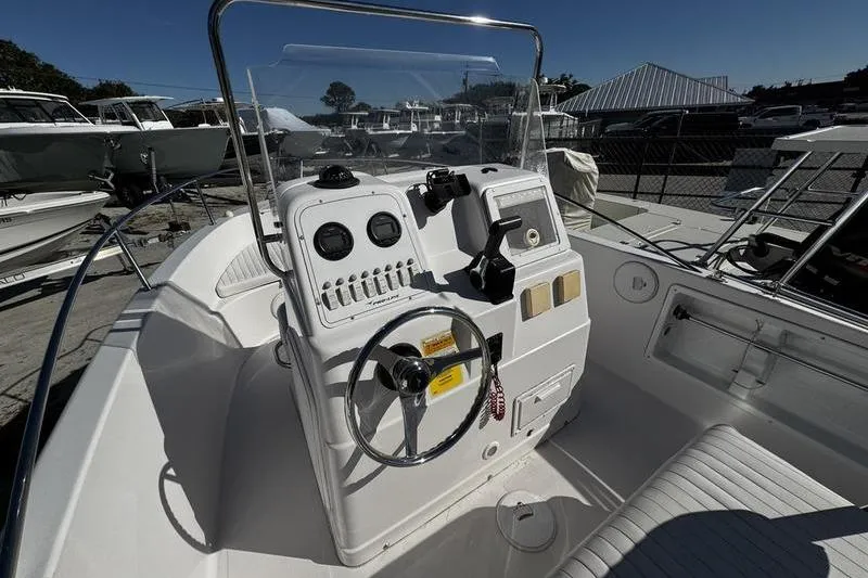 Slide: The Image of 2002 Pro-Line 19 Sport boat cockpit with steering wheel and control panel. - 8